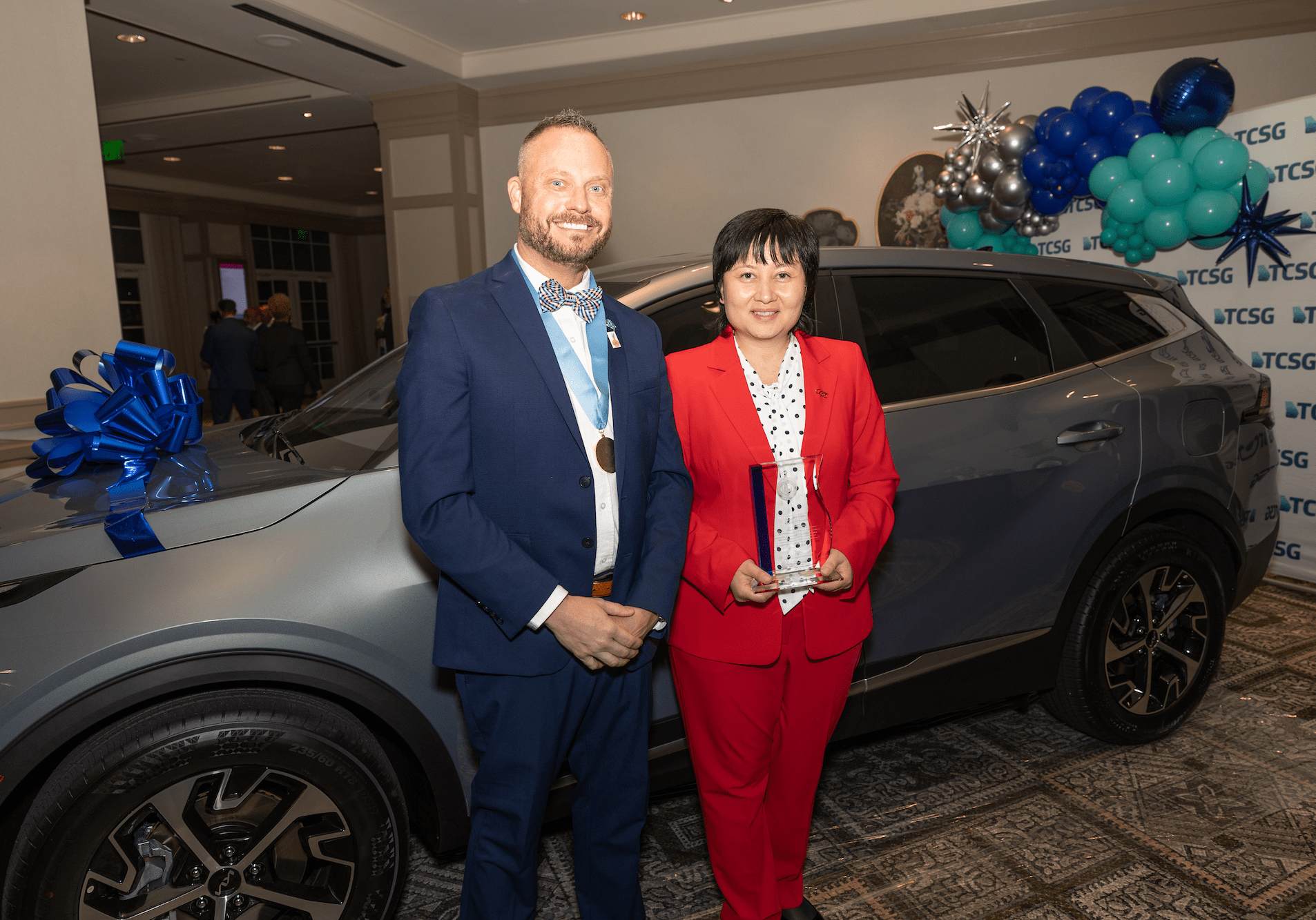 2025 GOAL and RPA Winners standing in front of the winner's car.